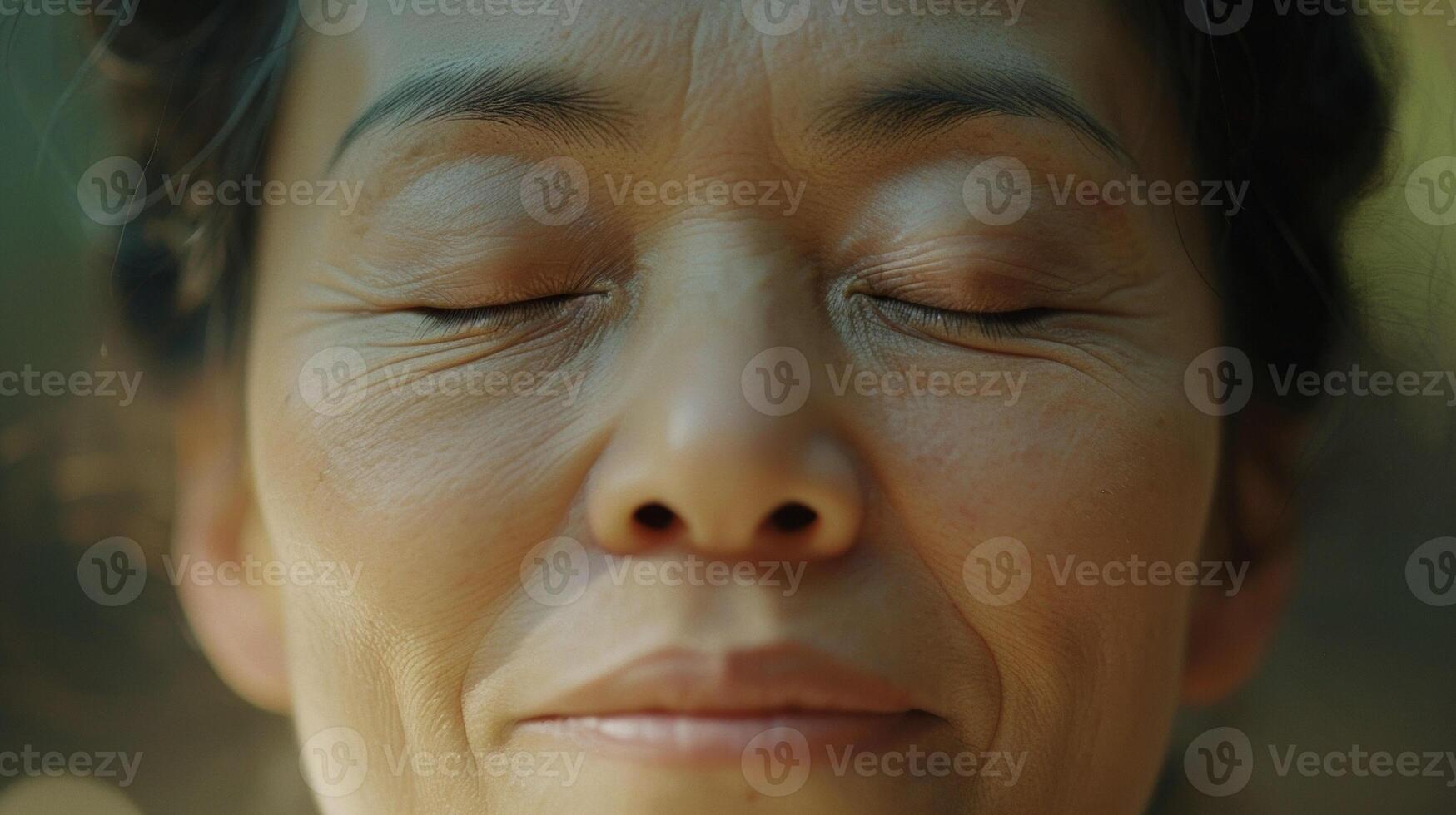 A closeup of a persons eyes closed in meditation while practicing Tai Chi their breath deep and steady as they connect with their mind and body photo
