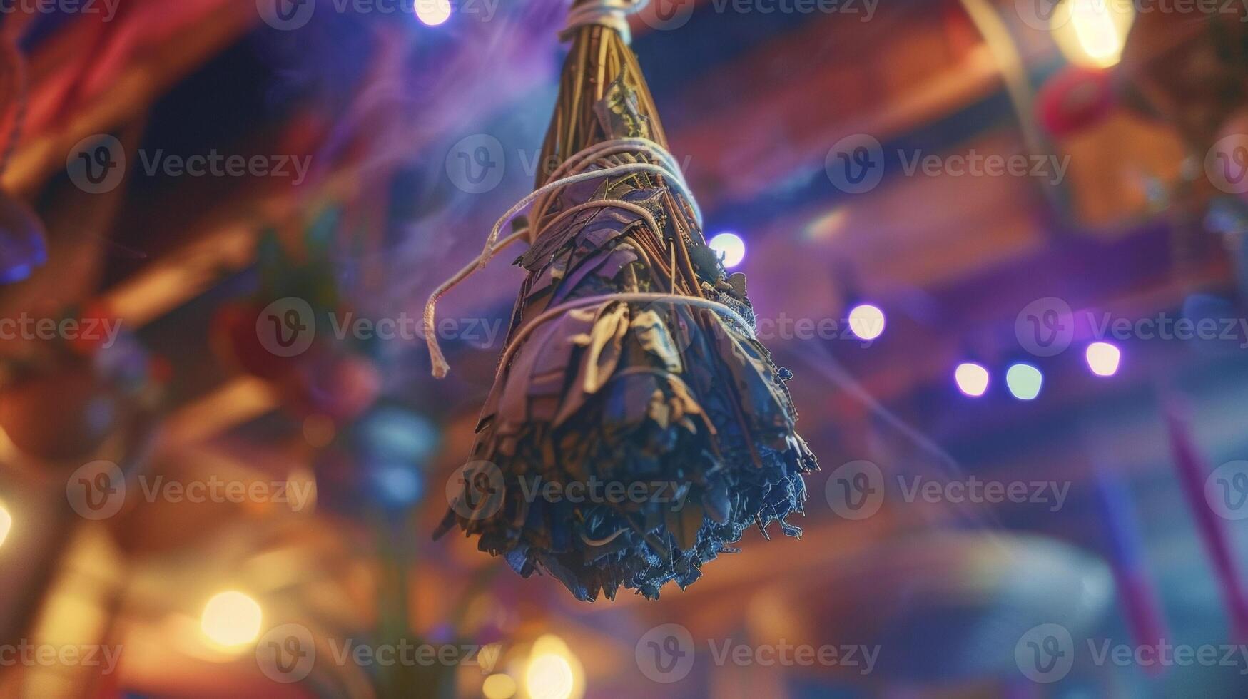 A bundle of dried sage hangs from the ceiling symbolizing the cleansing and healing powers of traditional smudging rituals photo