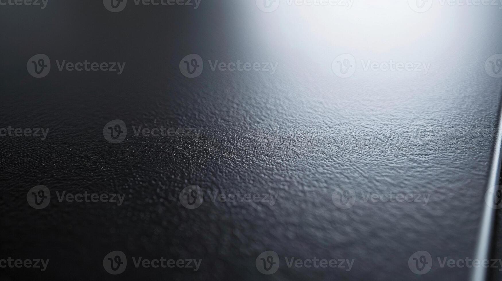 A closeup of an aerographitecoated surface displaying a smooth and seamless finish with a slight sheen to it photo