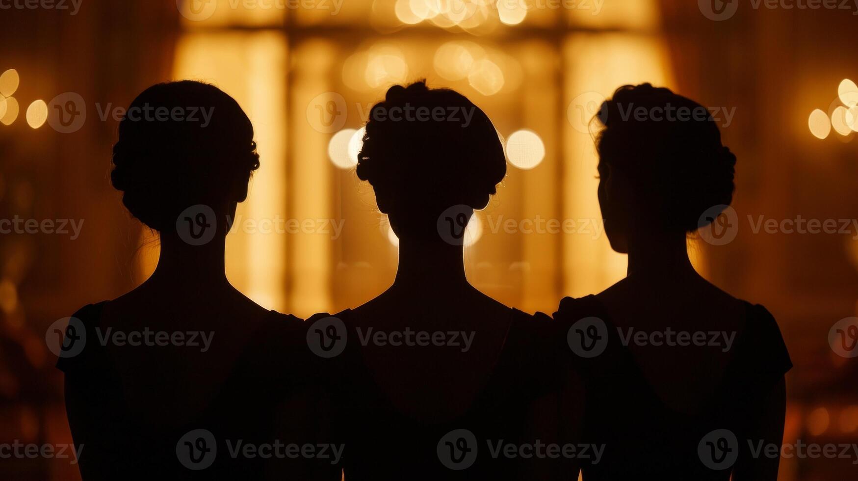 The silhouettes of three goddesses command the attention of the room presence radiating an air of authority and intelligence. . photo