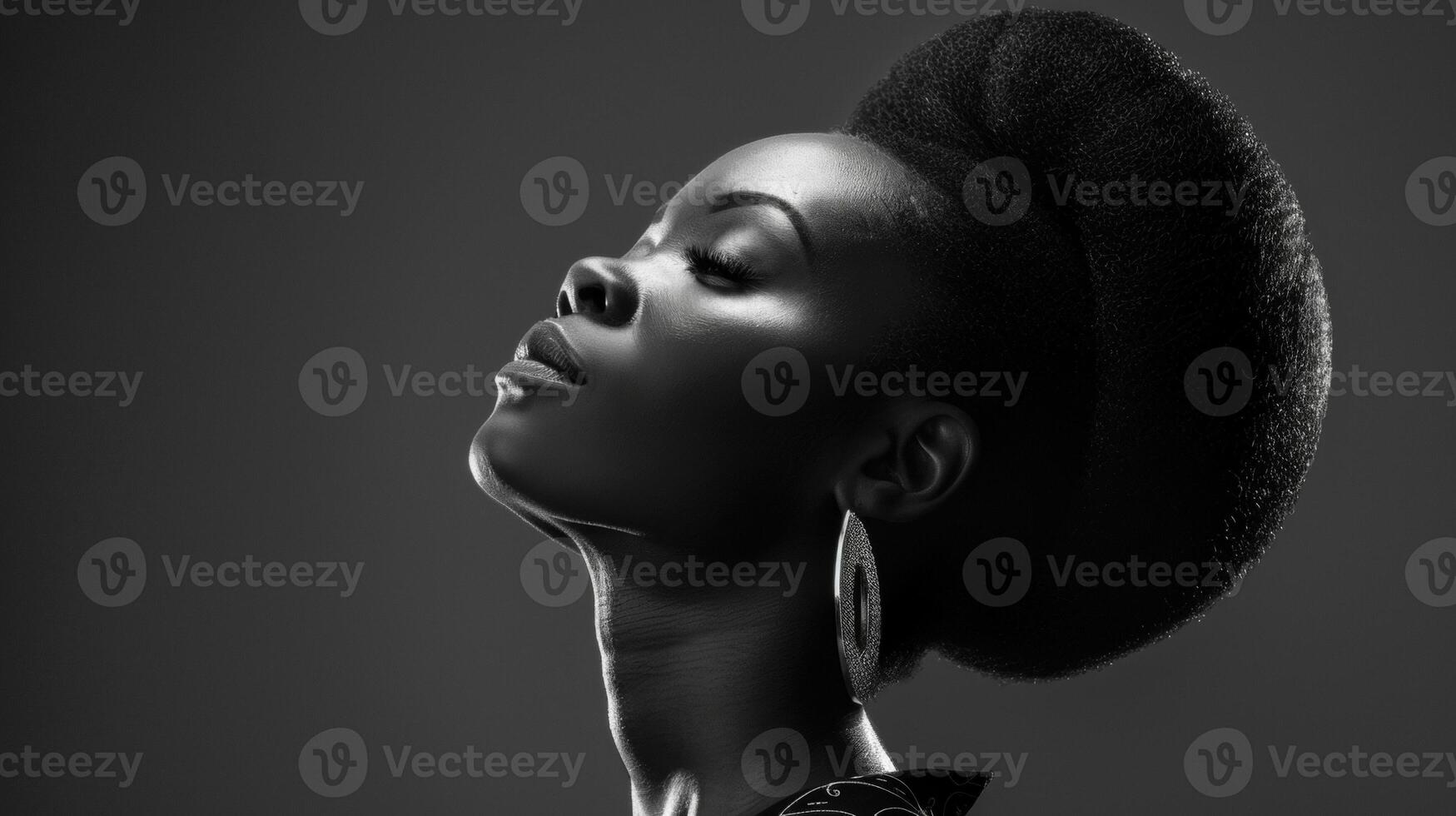 A regal black woman stands tall her elegant features and sleek hairstyle highlighted by the monochrome color scheme emphasizing her refined power. photo