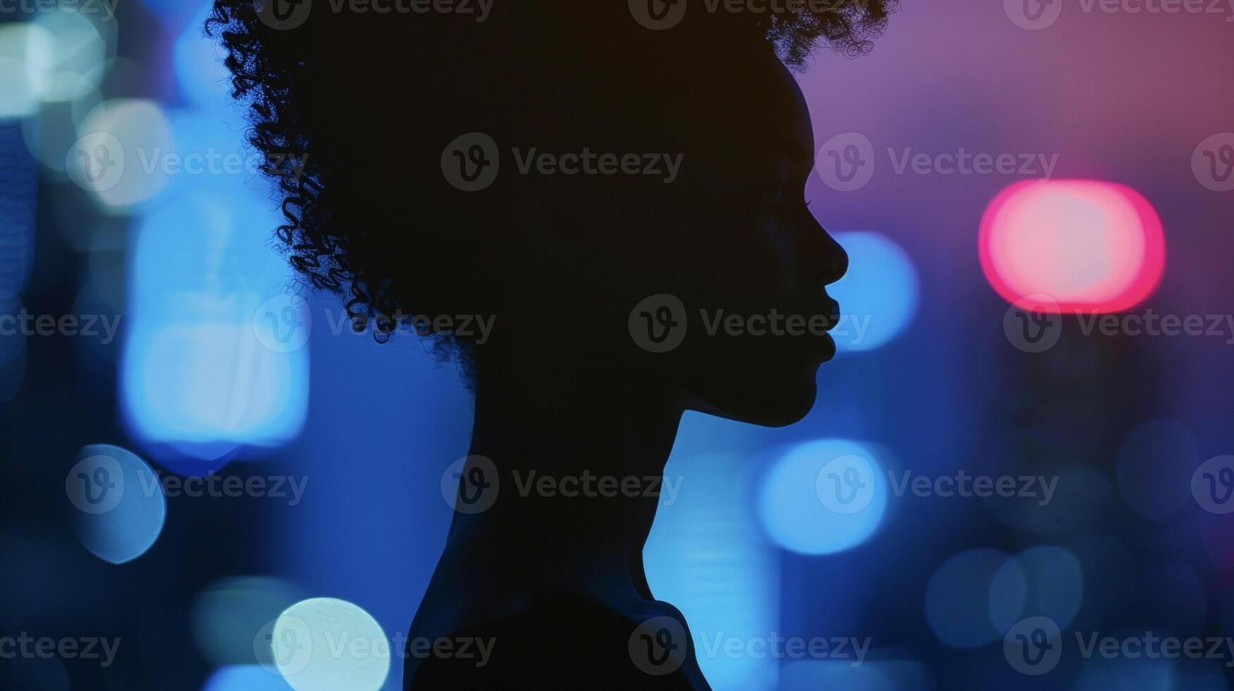 A striking silhouette of a powerful black woman her sharp features outlined against the soft glow of city lights. She exudes a timeless glamour that captures the eye with its mysterious photo