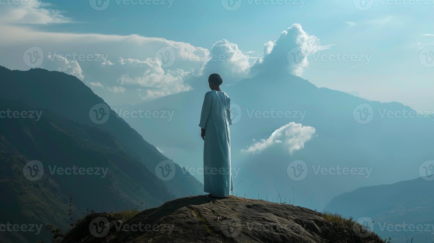 A midwife stands on a mountaintop a symbol of her unwavering strength and courage in the face of the challenging and emotionally demanding duties she fulfills as she supports women photo