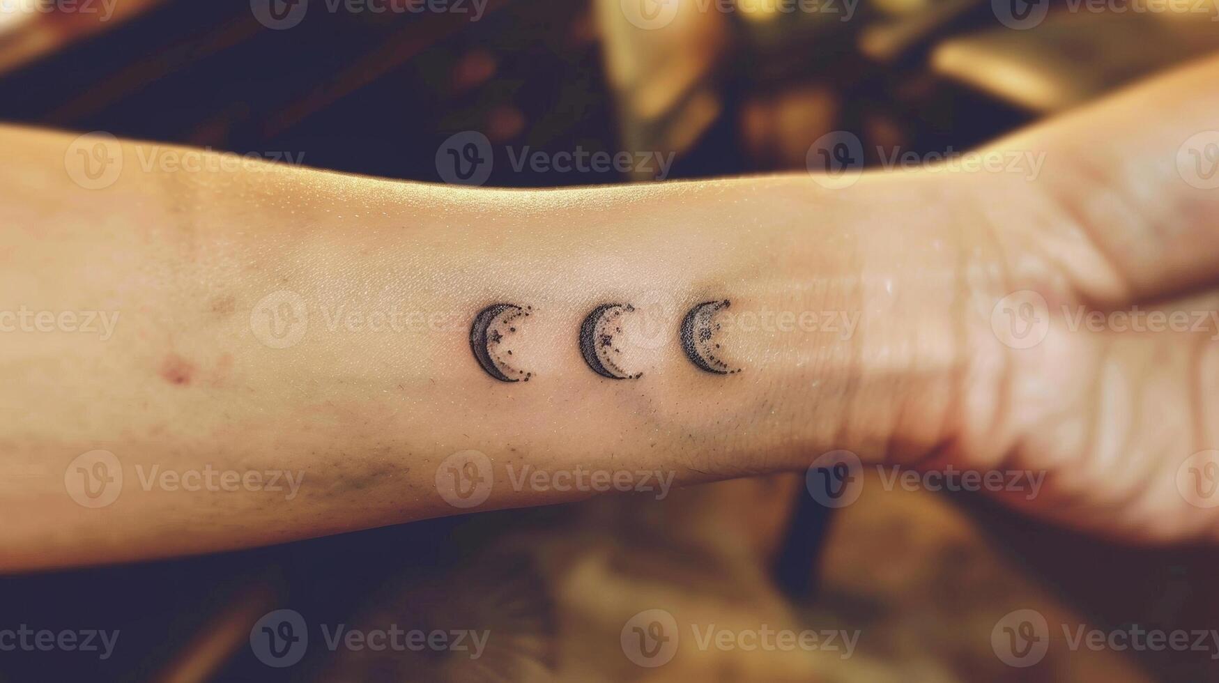 On their wrist a tiny moon phases tattoo serves as a reminder to embrace change and the natural cycles of life. photo