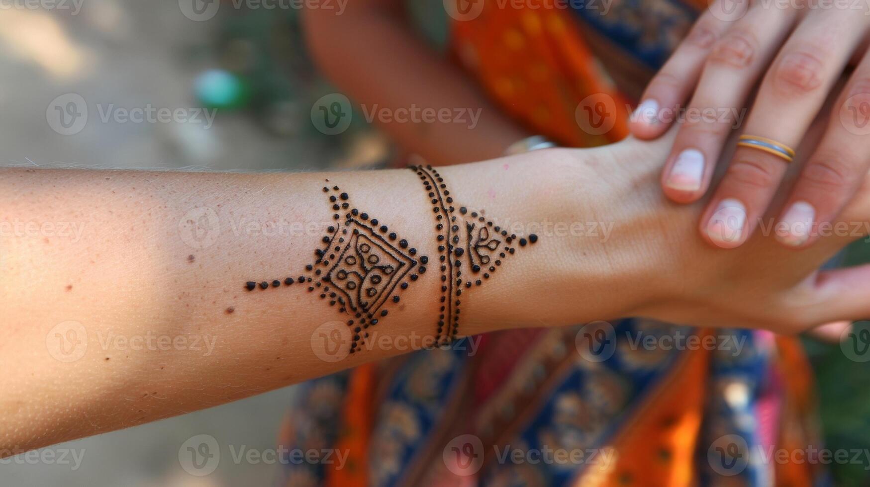 A thin tan line around her left wrist marks the location and significance of the henna tattoo she got on a trip to India. photo