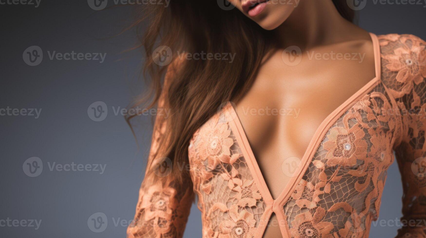 Closeup of a Peach Fuzz lace jumpsuit, with a plunging lace neckline and lace panels on the sides for a and sophisticated look. photo