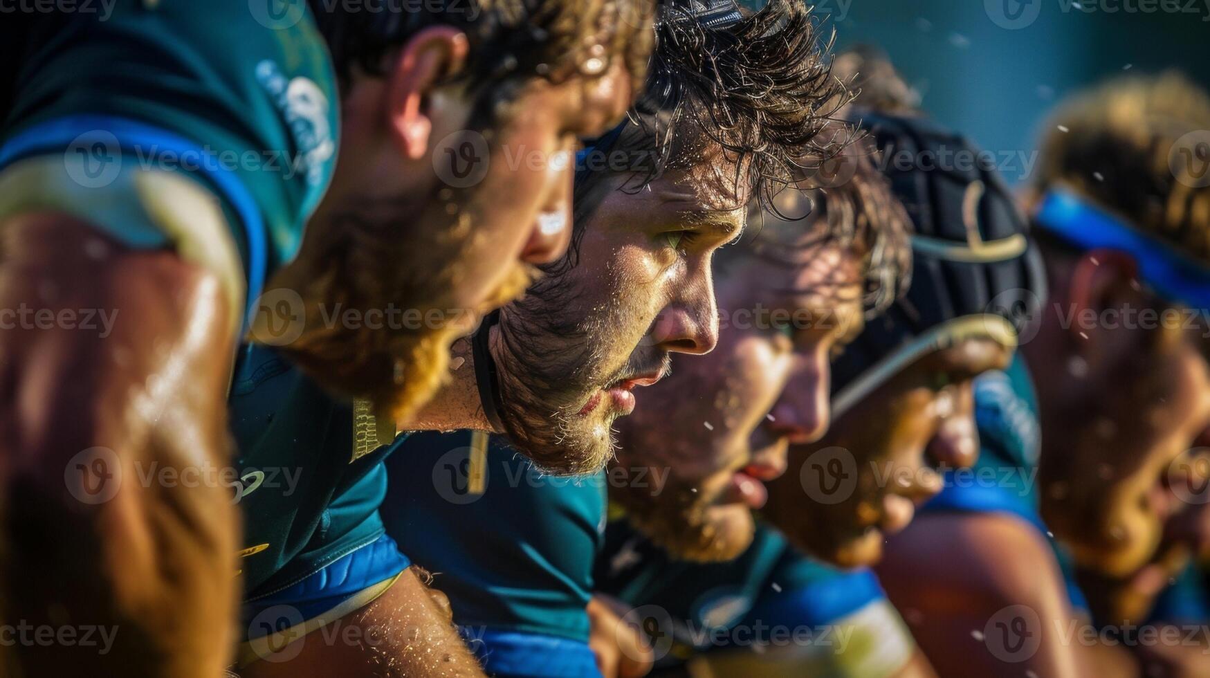 Intense concentration and determination on the faces of rugby players locked in a scrum at the stadium photo