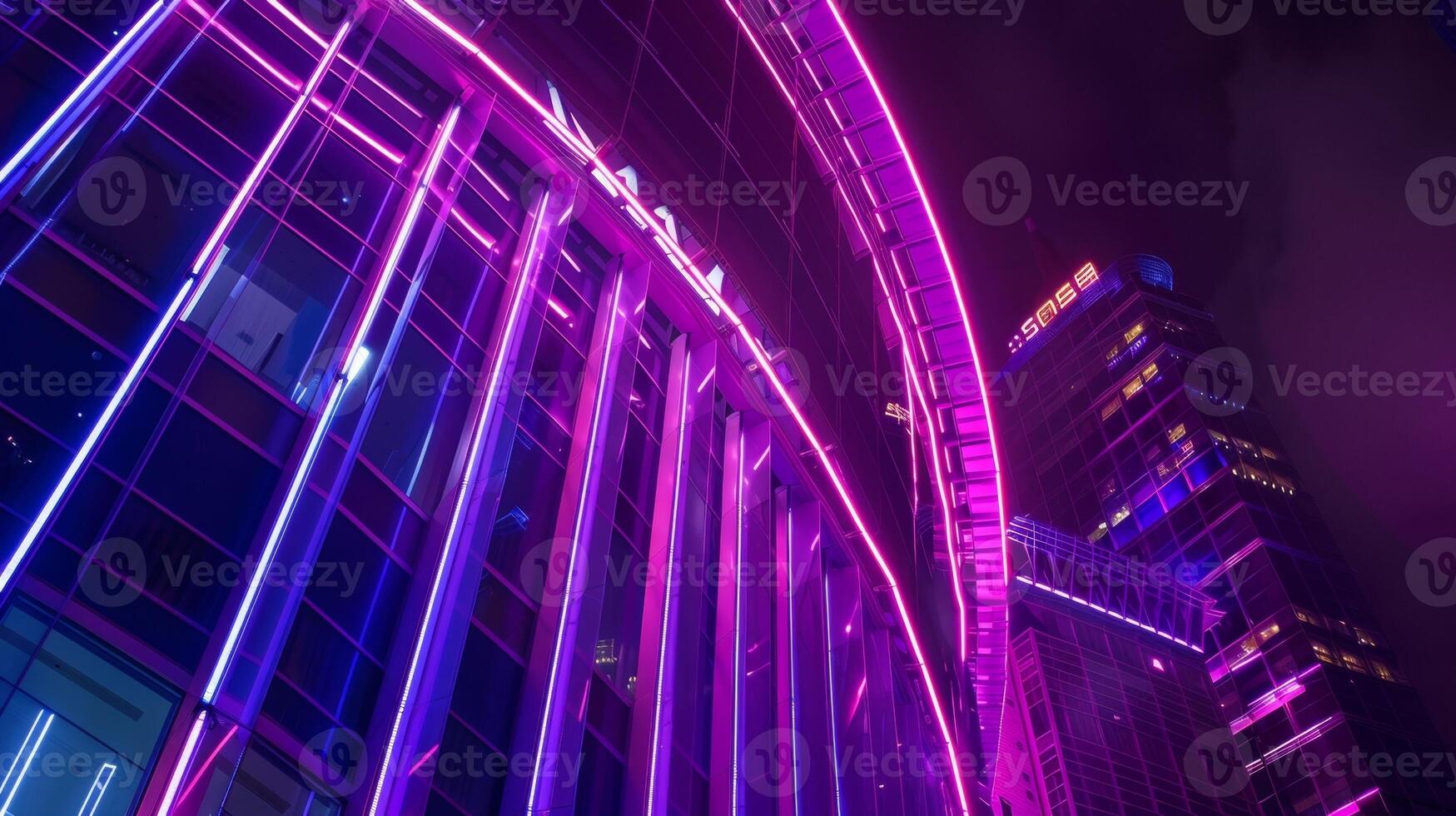 Neon lights illuminate the exterior of this vertical stadium making it a vibrant and eyecatching addition to the urban landscape photo