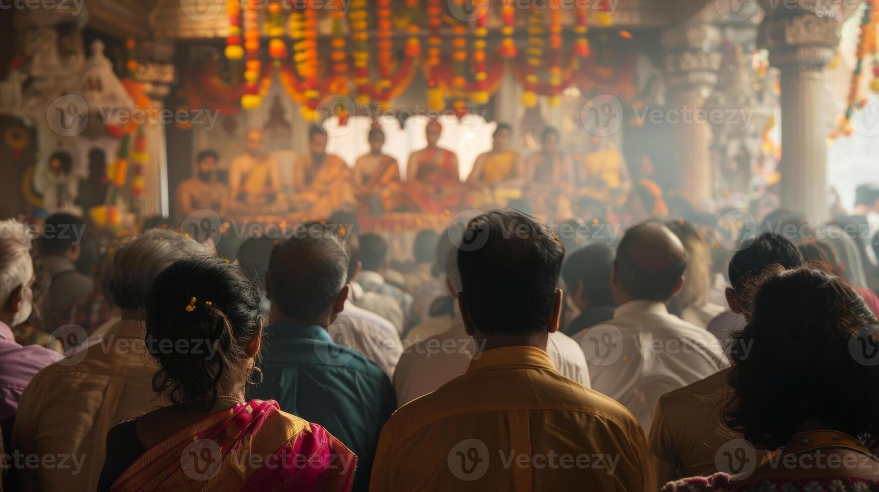 A reverent gathering facing away from the camera in the midst of a religious ceremony where music and chanting reverberate through . photo