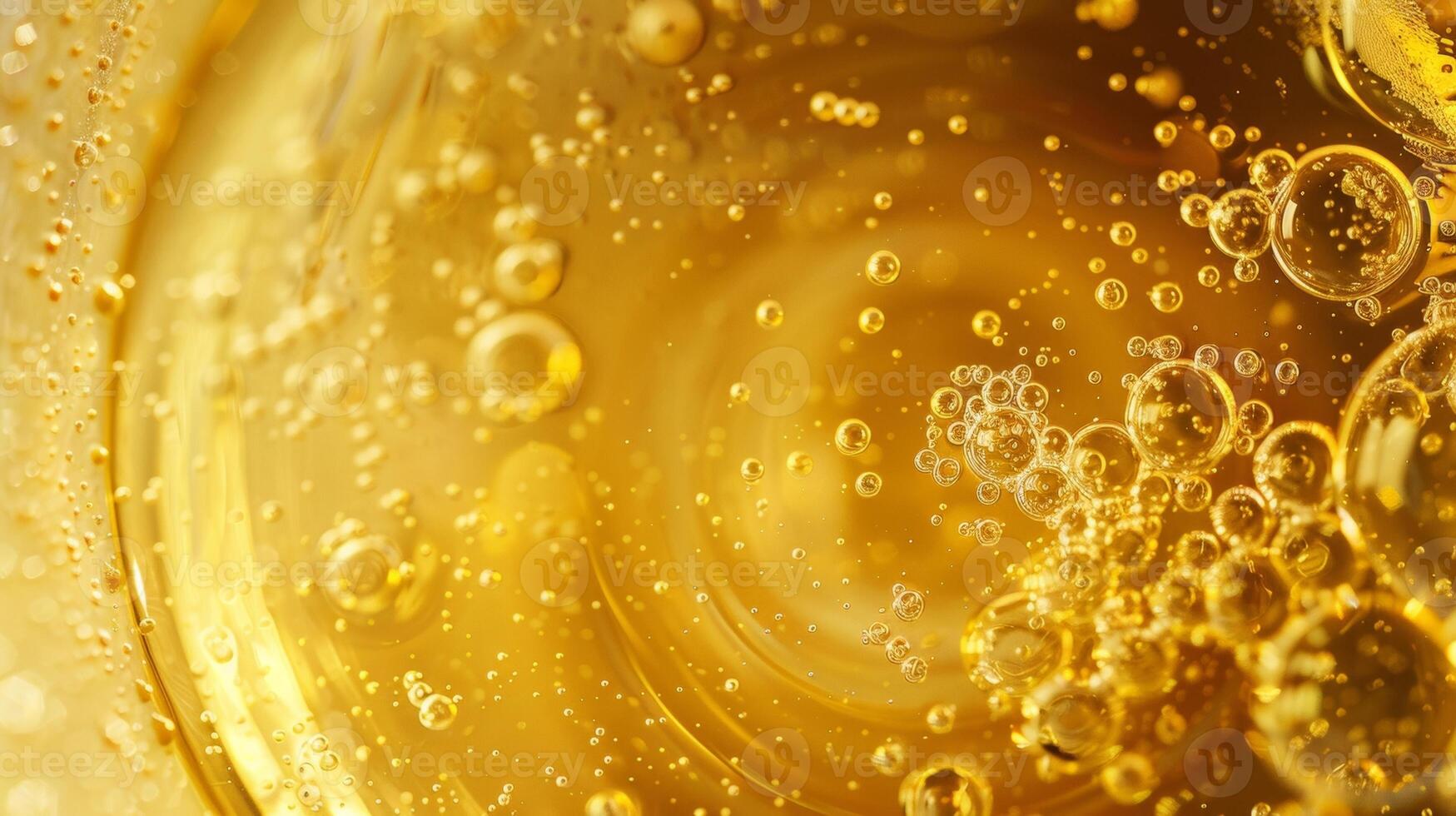 A magnified view of the inside of one of the containers revealing a smooth golden liquid with tiny bubbles floating to the surface. photo