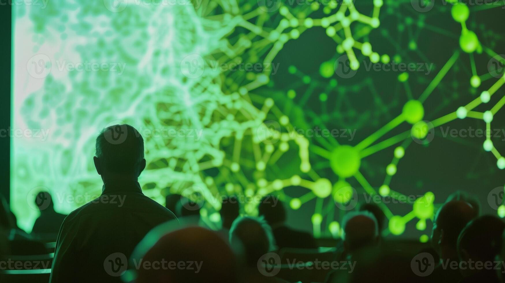 An animated diagram depicting the process of converting algae into biofuel as described by a presenter in front of a captivated audience. photo