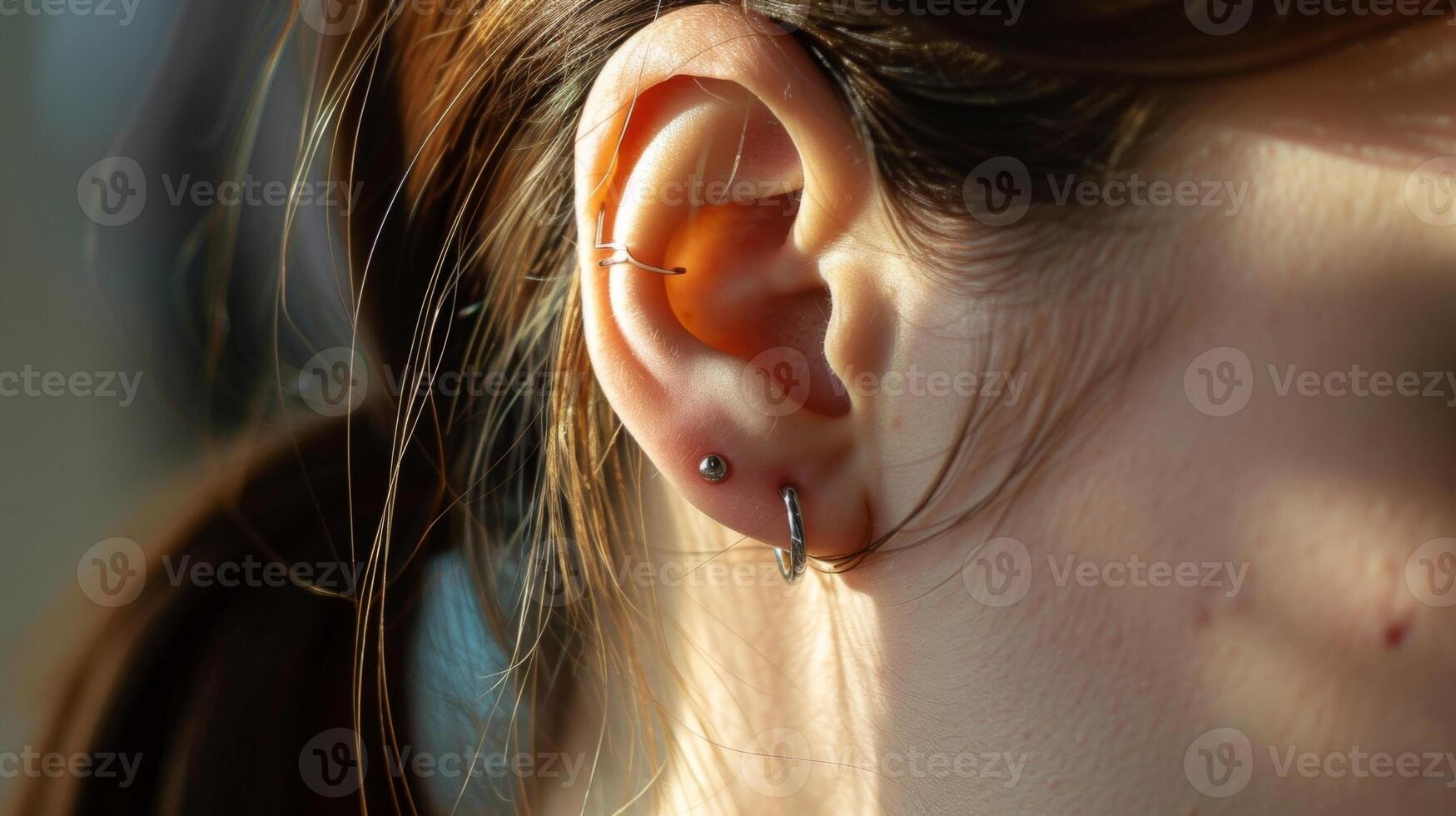 The piercing in the ear a symbol of rebellion against the constraints of time. photo