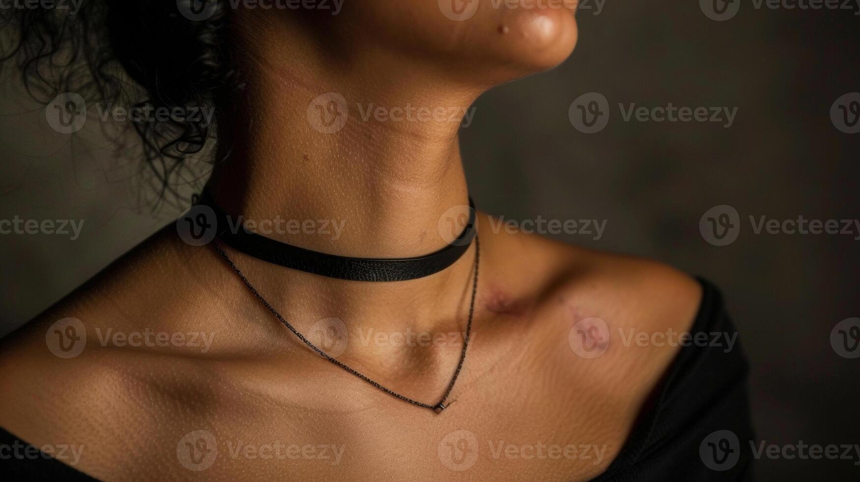 The scars on a womans neck where a choker necklace once rested symbolize the freedom and liberation she has found in being true to herself. photo