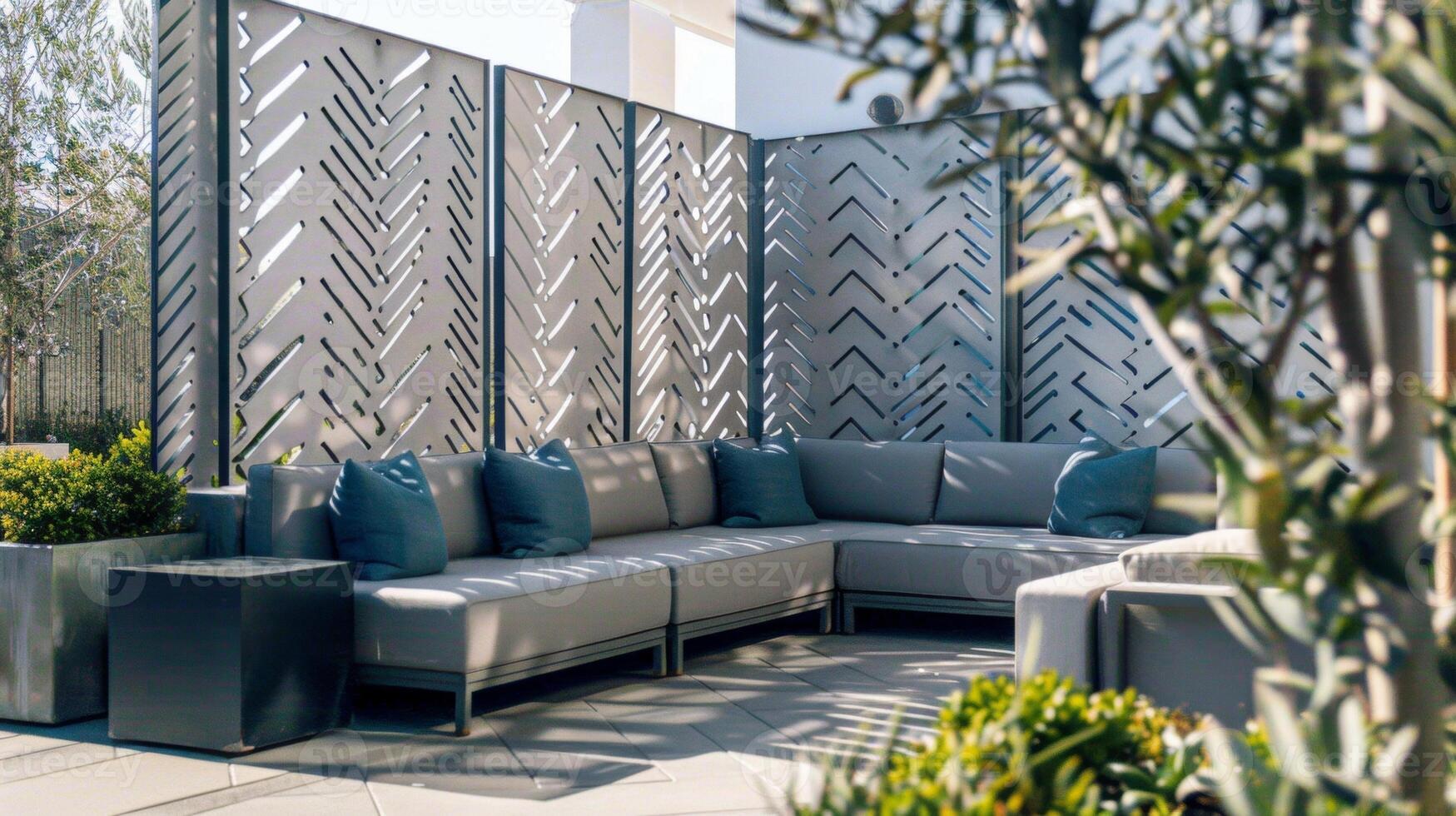 The seating area is divided by a series of geometric concrete screens each with a unique pattern etched into its surface. From intricate herringbone to bold chevron these concrete photo