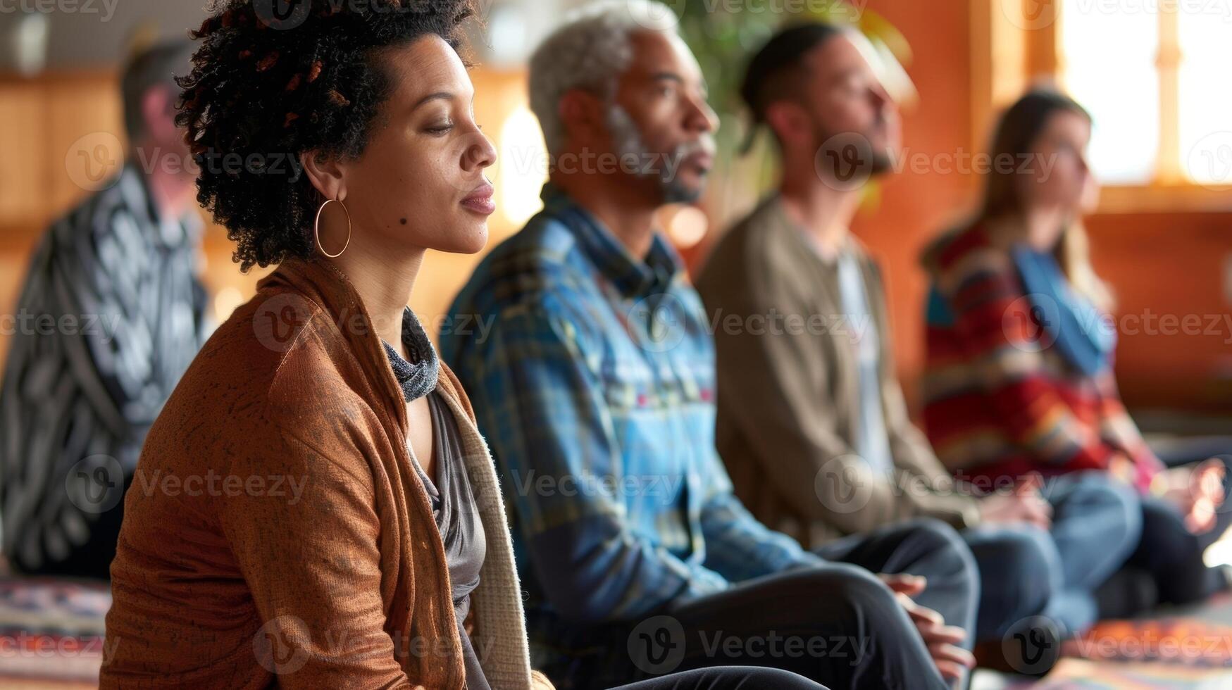 A group of individuals sitting in a meditation room participating in a mindful listening workshop photo