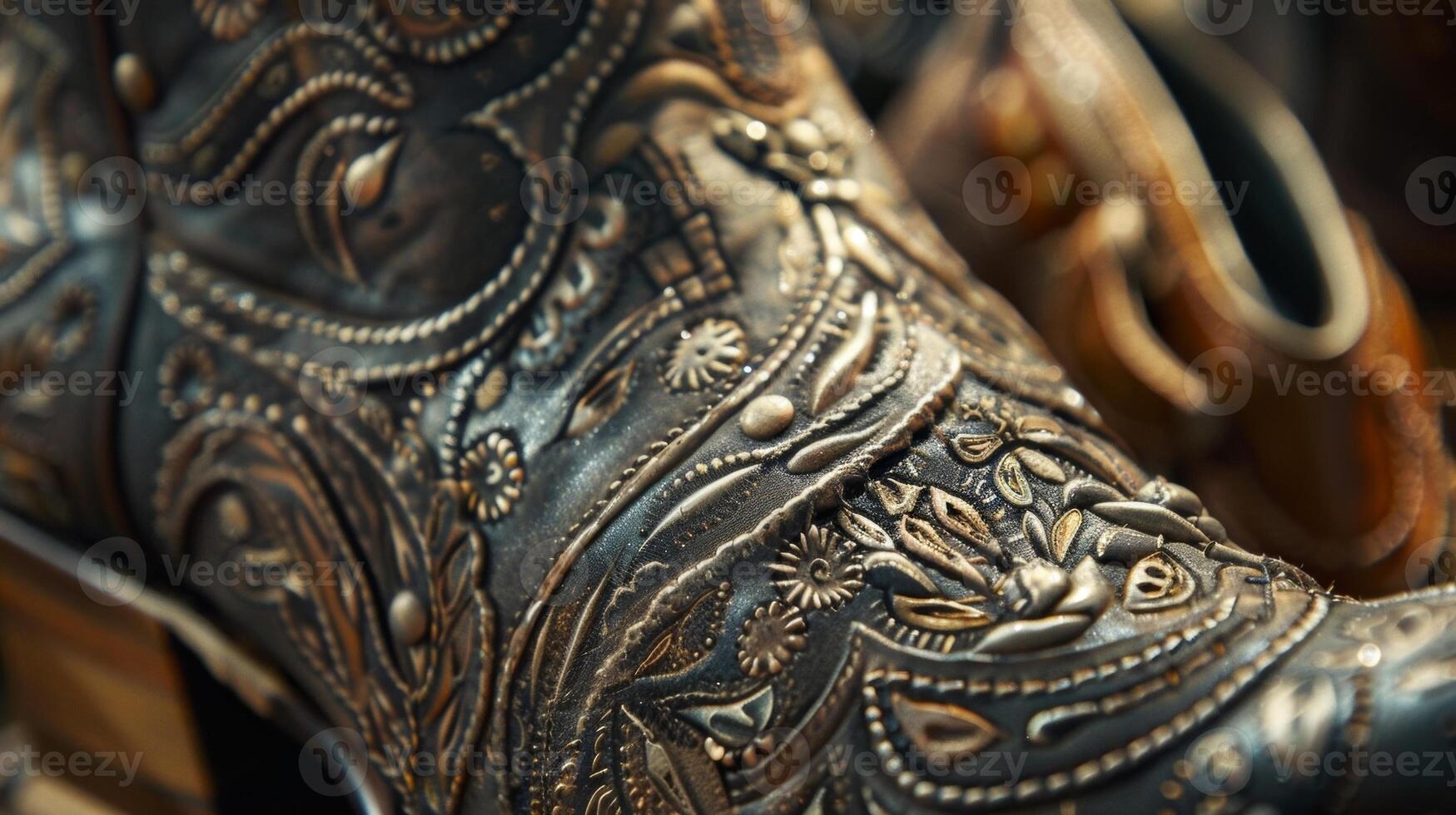 A display of intricately tooled leather boots with detailed stitching and metal embellishments photo