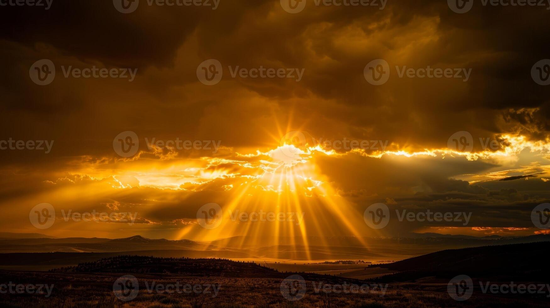 The sun peeks out from behind an ominous storm cloud casting a golden spotlight on the landscape photo
