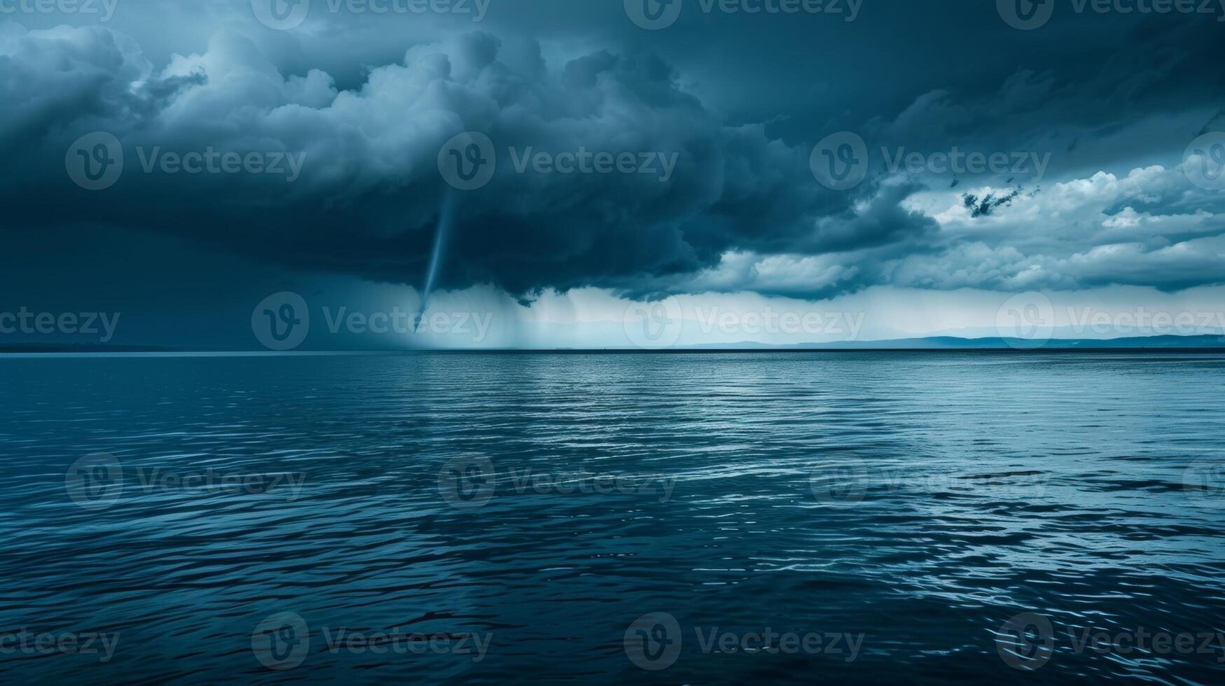 The calm before the storm as a singular water spout forms a warning of the chaos to come photo