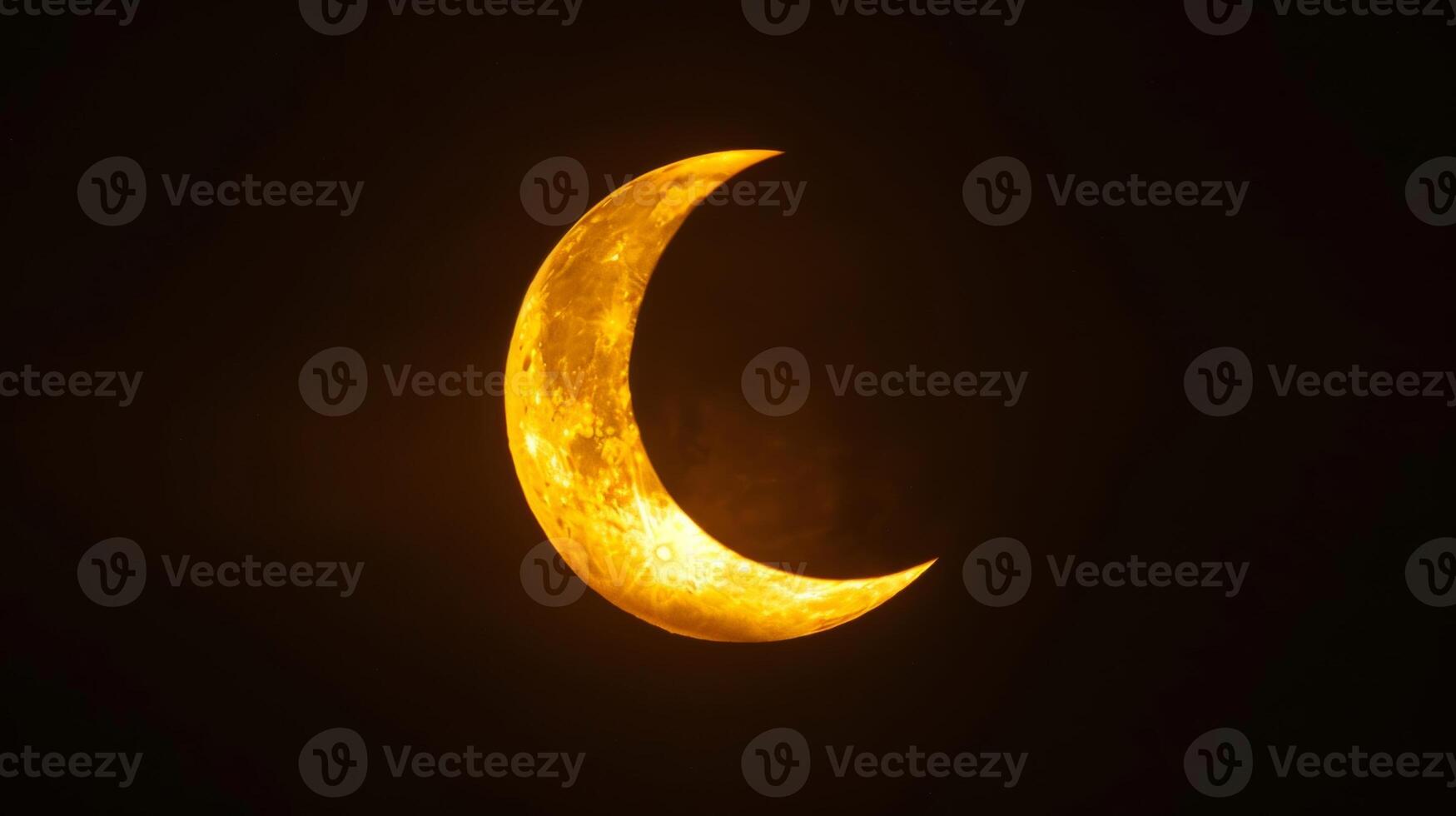 The sun partially hidden behind the moons shadow during a solar eclipse reminding us of the moons powerful influence on Earth photo