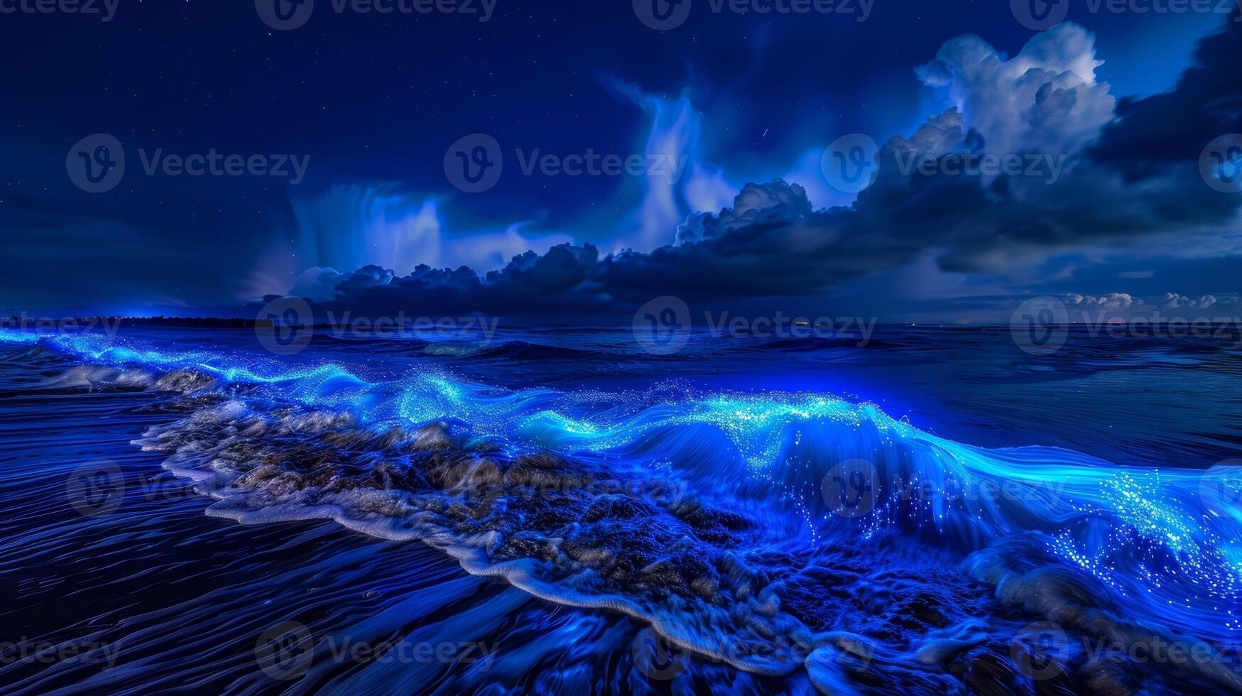The waves come alive with a pulsating blue glow as the bioluminescent plankton create a natural light show photo