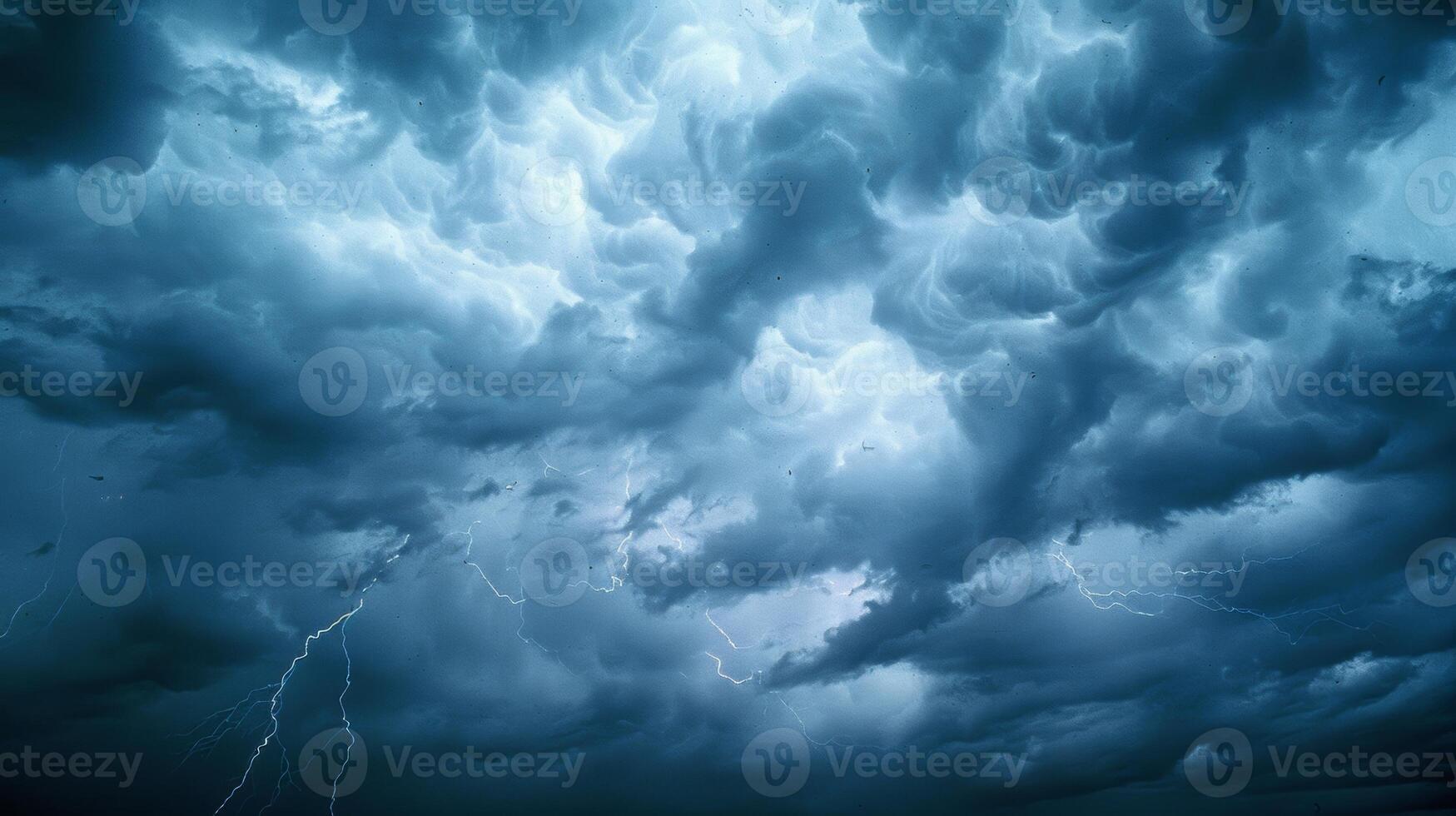 Rain pours down as lightning lights up the sky revealing the ragged edges of storm clouds photo