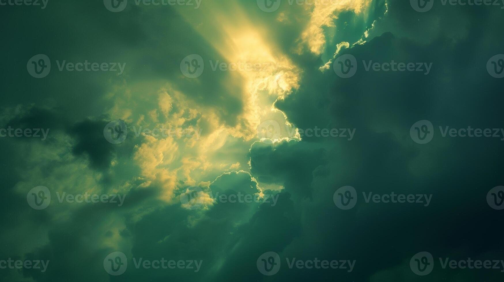 Shades of lime mint and jade illuminate the sky as the suns final rays pierce through the clouds photo