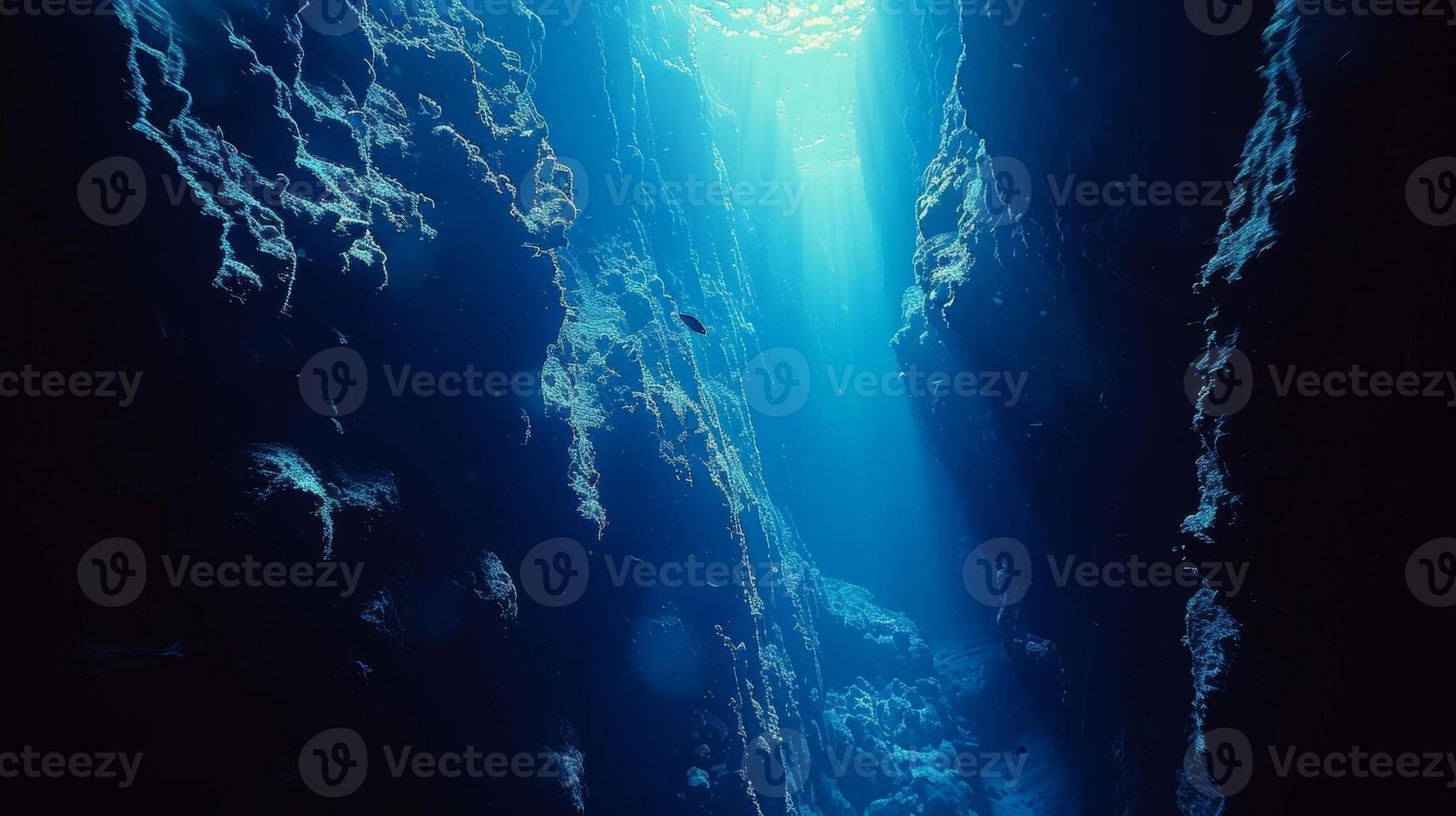 A deep and mysterious ocean abyss inhabited by luminescent creatures adapted to survive in the depths photo