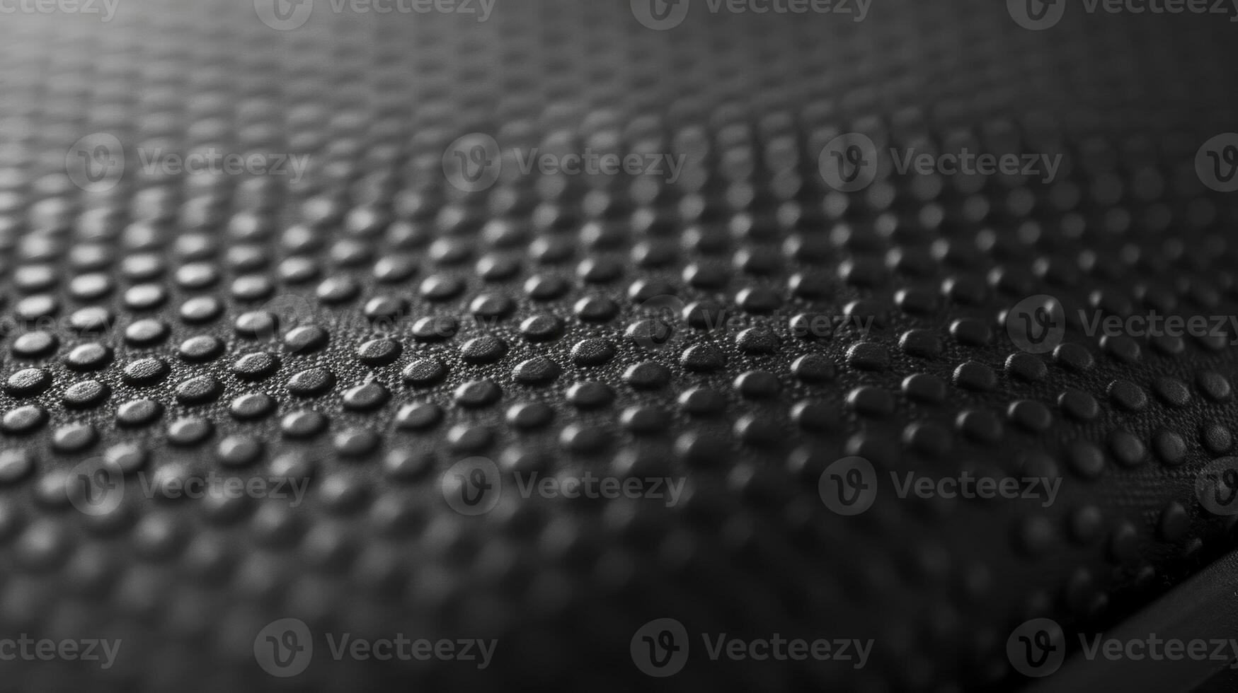 The texture of a smooth rubberized material that resembles the protective cover on a lithiumion battery providing a sy and comfortable grip photo