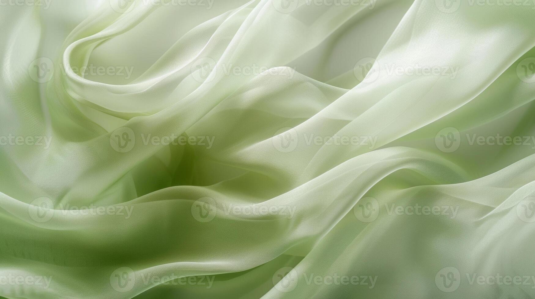 A closeup of pale green silk chiffon shows the lightcatching sheen and airy texture of the fabric photo