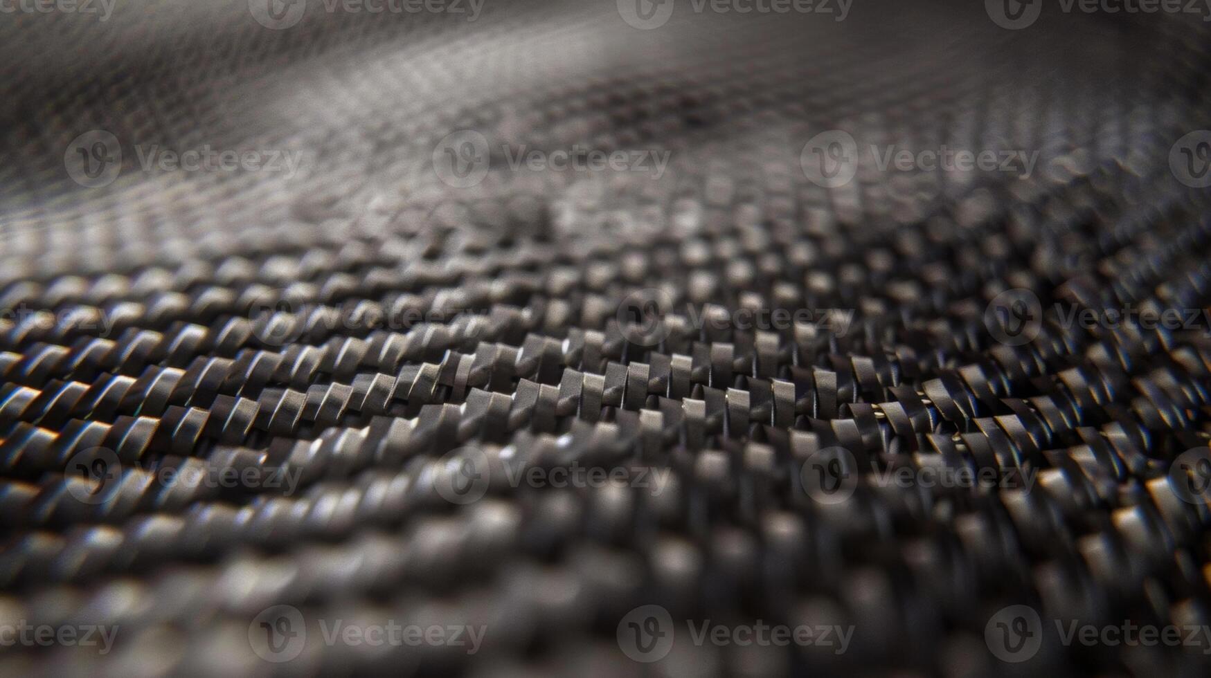 Imperfect strands and ridges weave throughout the carbon fiber showcasing its raw and rugged nature photo