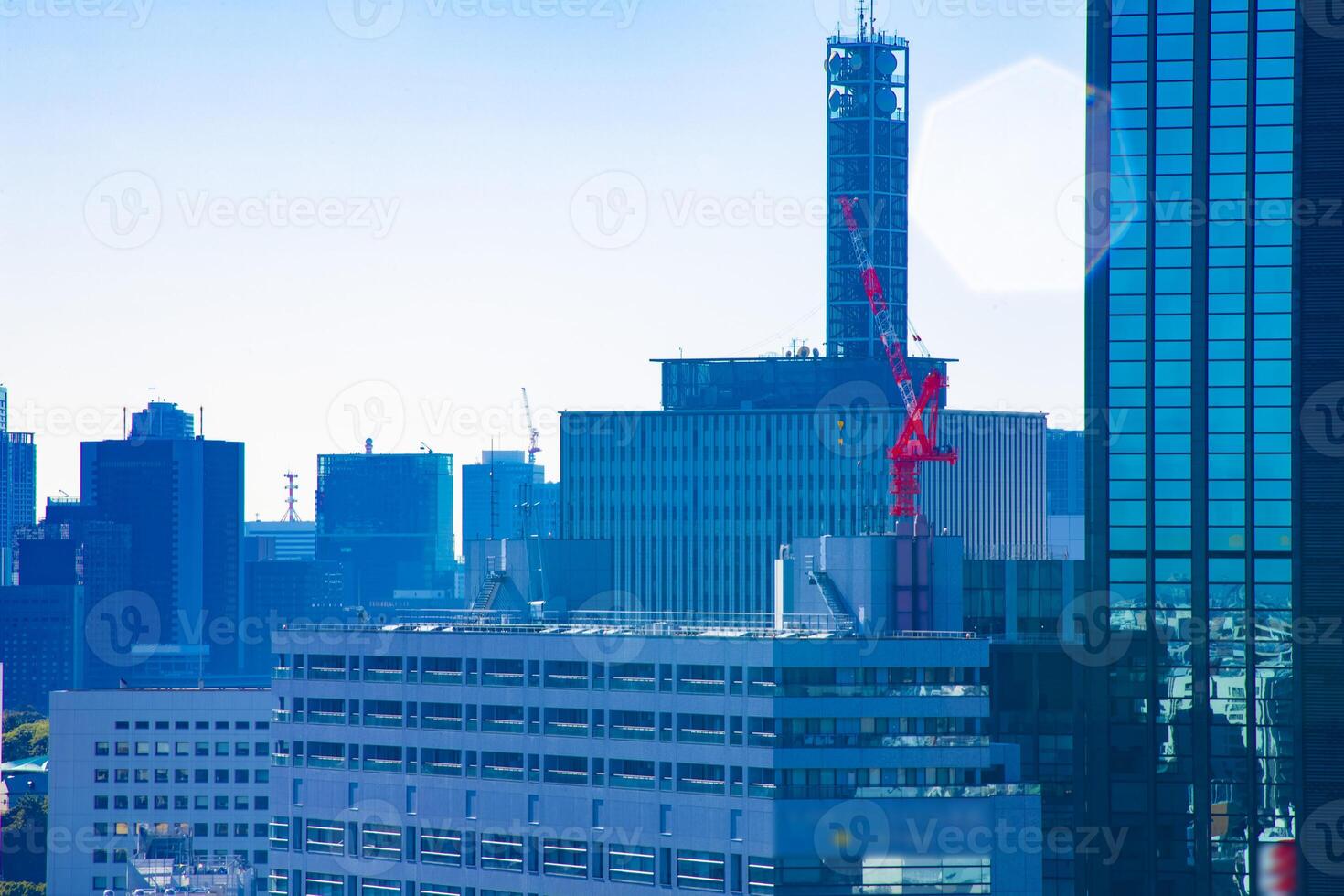 Moving cranes at top of the building in Tokyo long shot photo