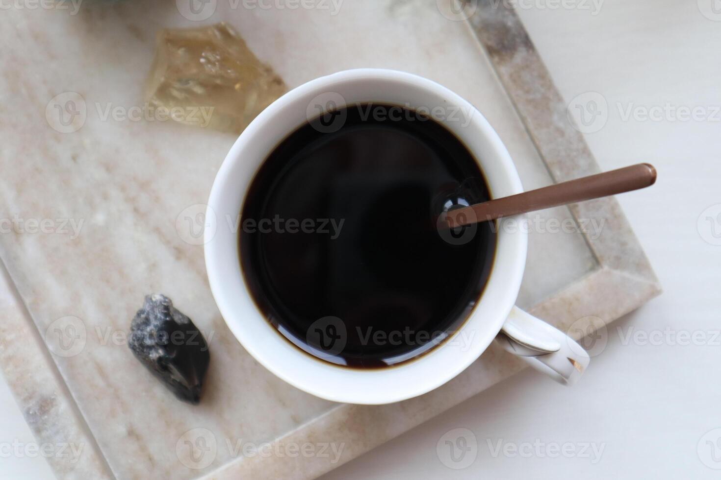 Cup of coffe on a marble tray. photo