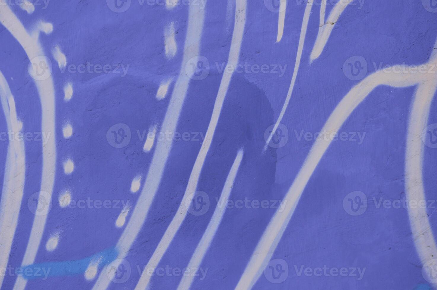 White waves and strokes on a blue background. Hand drawn abstract pattern of white stripes of wavy patterns on the wall of a building. photo