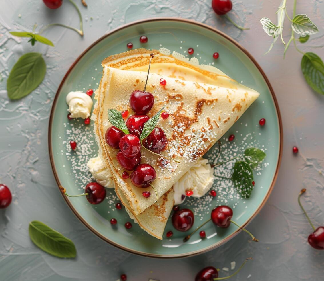 Close Up of a Stack of Crepes With Cherries and Whipped Cream in a Gray Bowl photo