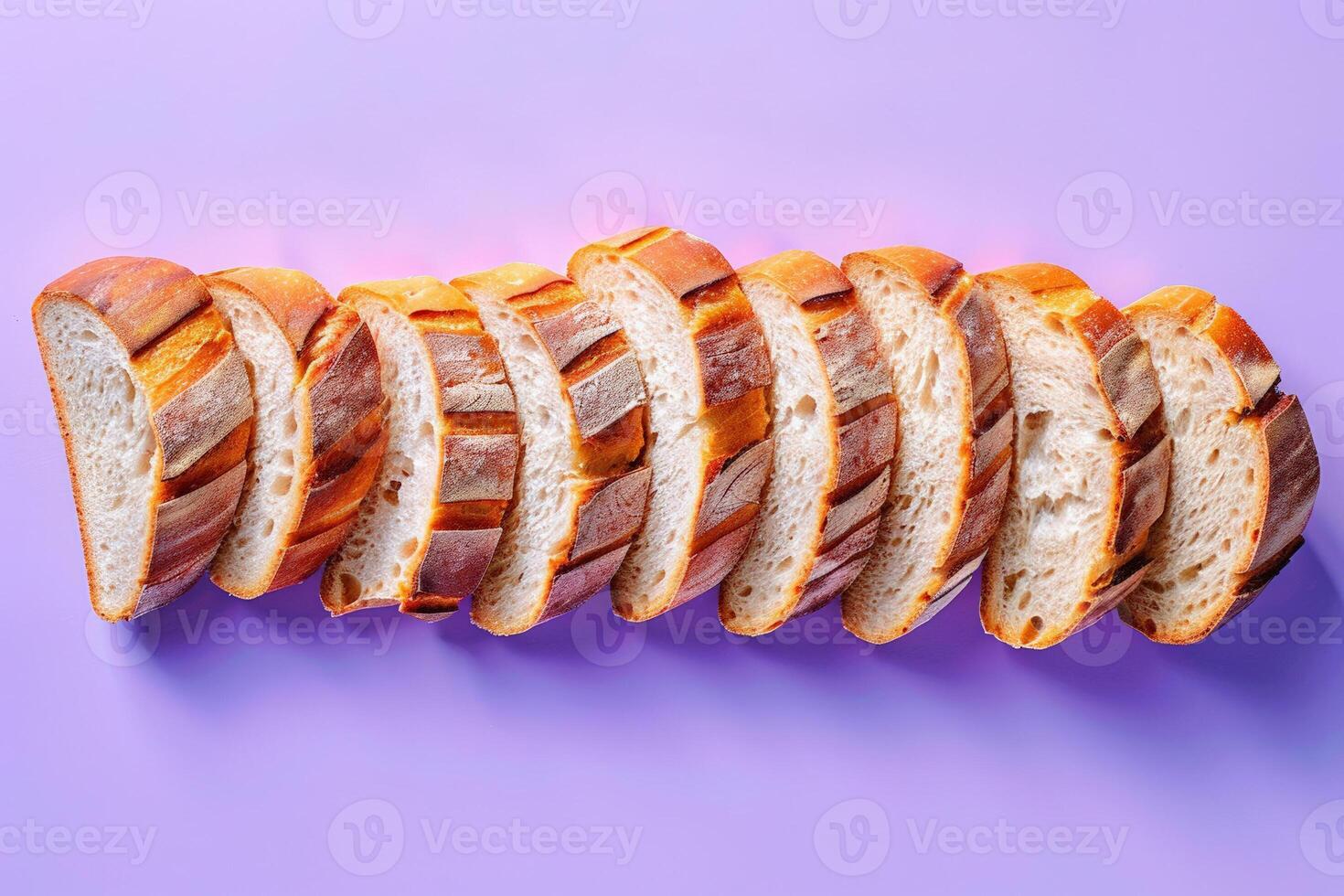 Sliced artisan bread arranged elegantly on a blue to purple gradient background, highlighting the texture and crust photo
