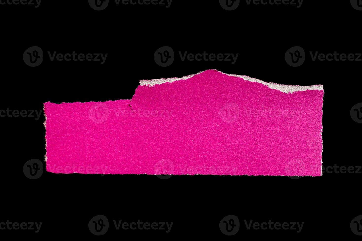 Ripped pink paper piece on isolated black background, torn paper with white edges photo