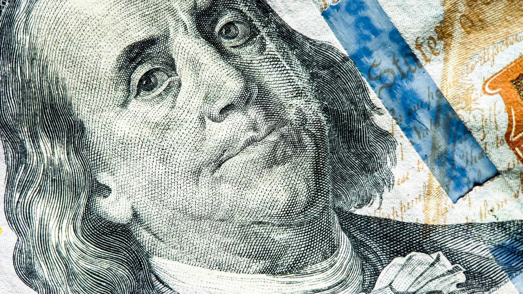 Close up of Benjamin Franklins portrait on a 100 US dollar bill, conceptually tied to finance, economy, and Presidents Day photo
