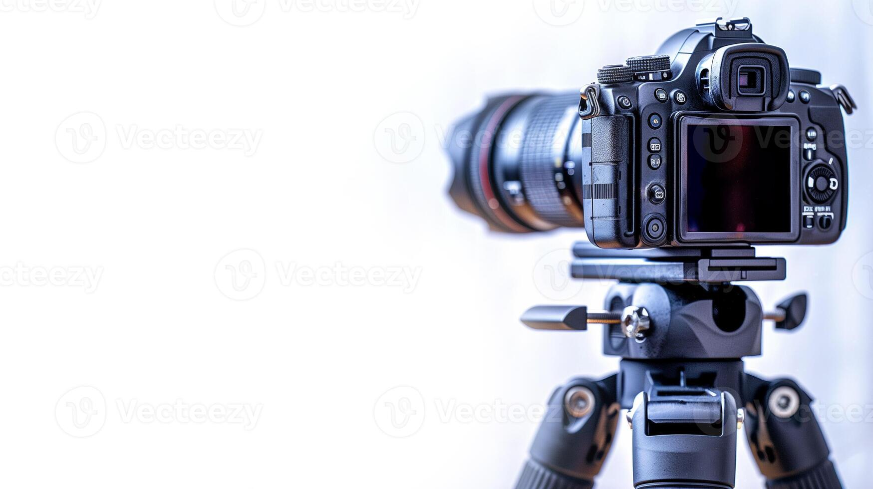Close up of a digital film camera on a tripod, isolated on white background photo