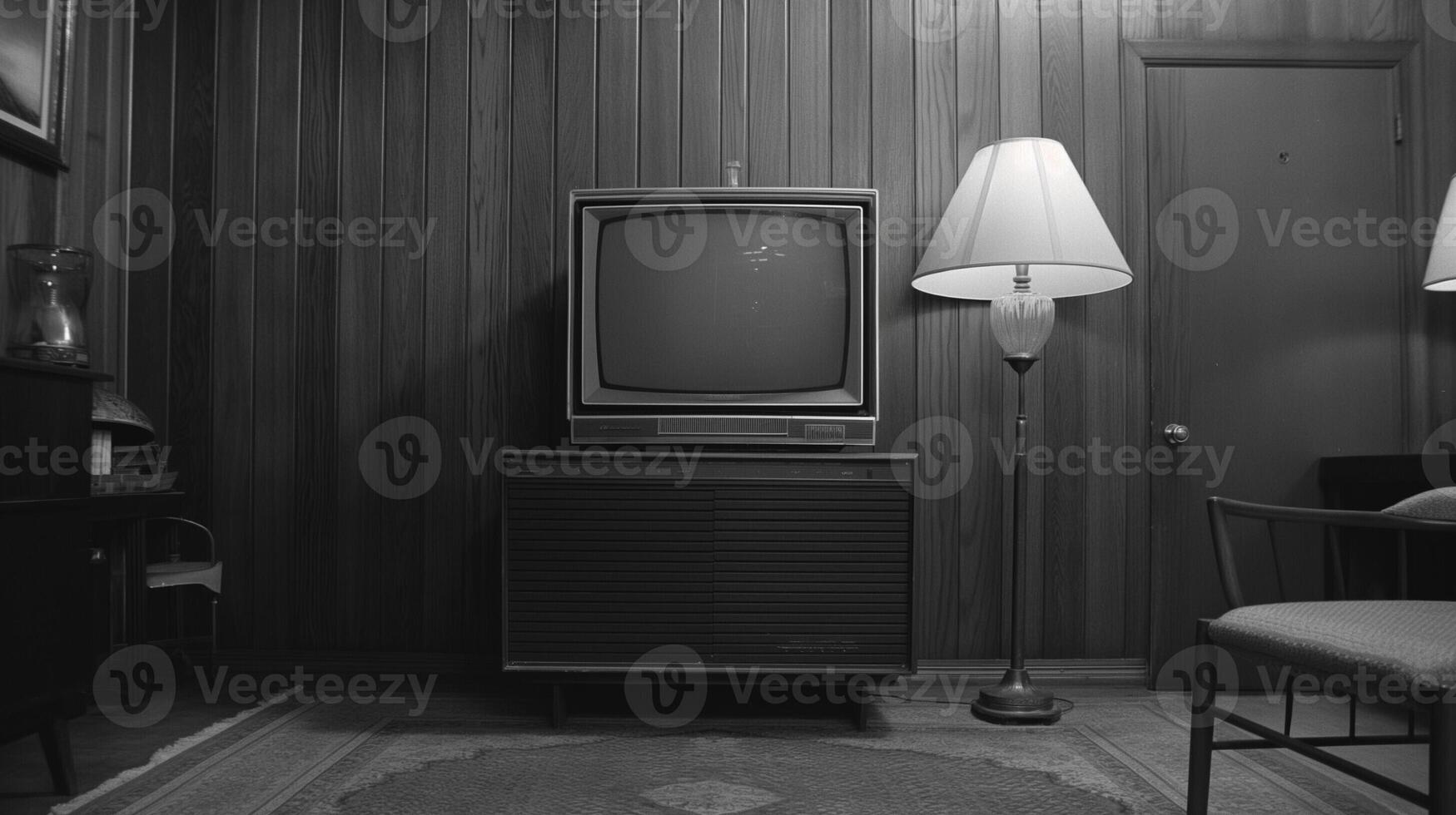 A vintage black and white TV broadcasting old commercials, wood paneled room photo