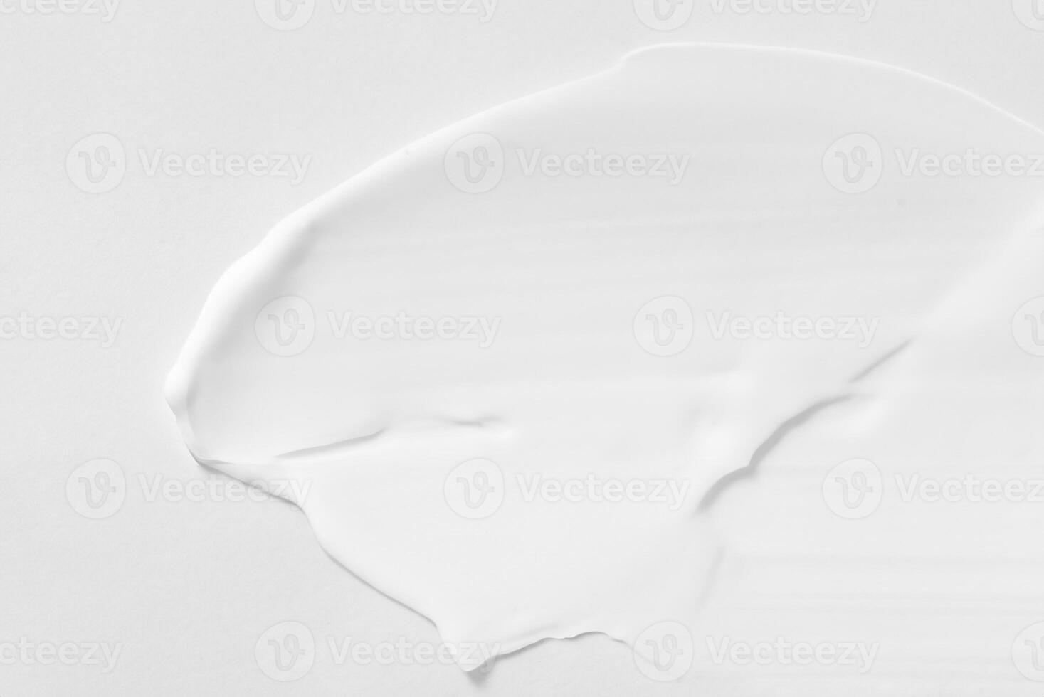 Close-up View of Thick White Cosmetic Cream Smears, Textured Background photo