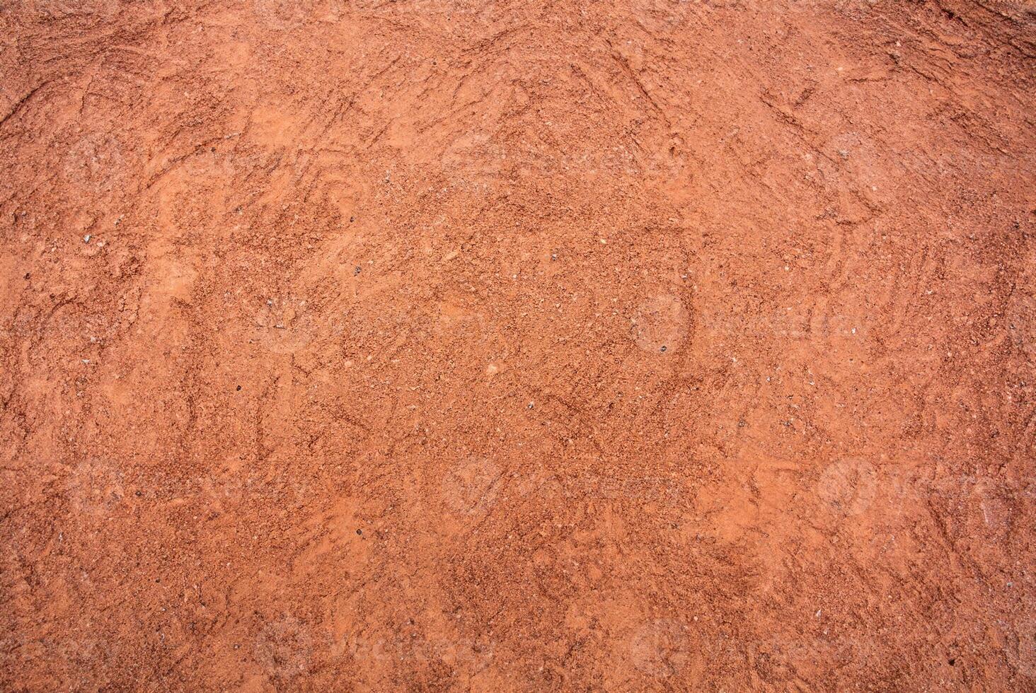 Red Sandy Surface Imprinted with Shoe Tracks, Texture Background photo