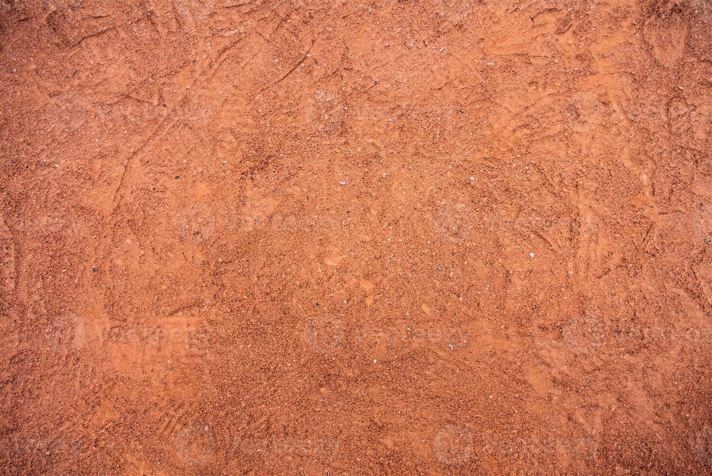 Red Sandy Surface Imprinted with Shoe Tracks, Texture Background photo