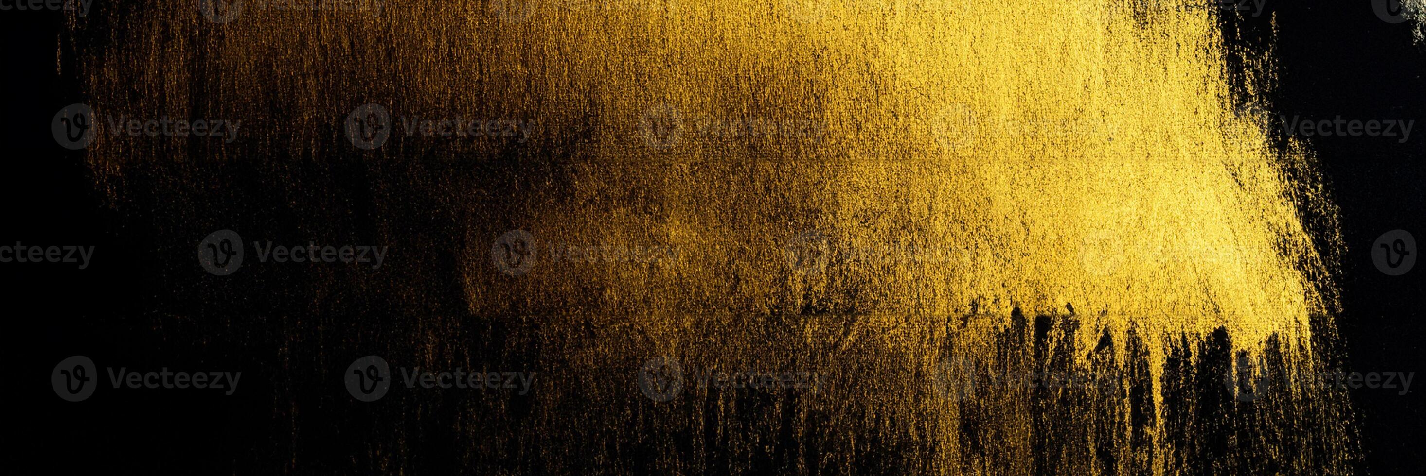 Acrylic Paint Stroke in Gold on Black Background photo
