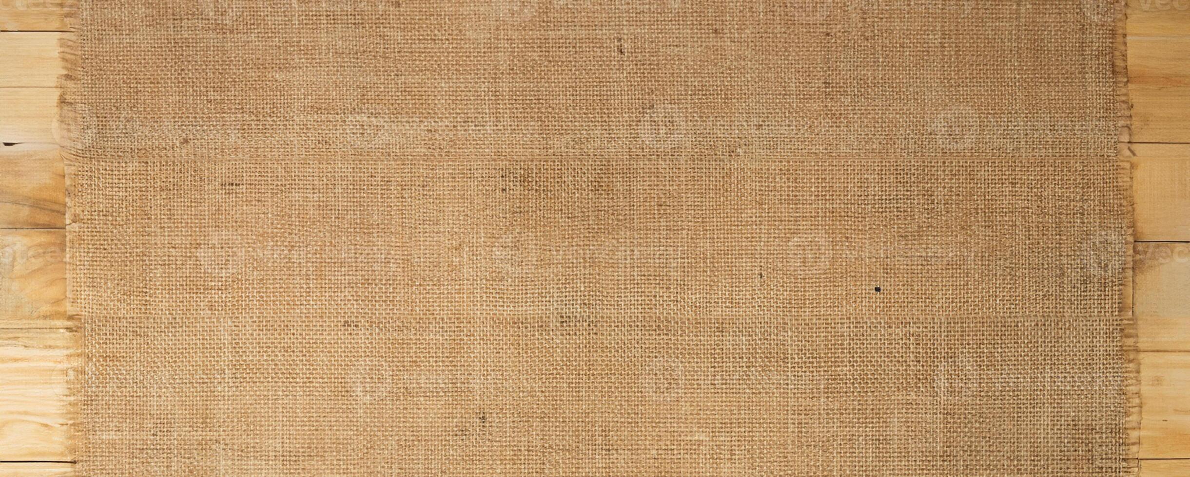 Burlap Fabric Texture on Wooden Surface, Rustic Background Concept photo