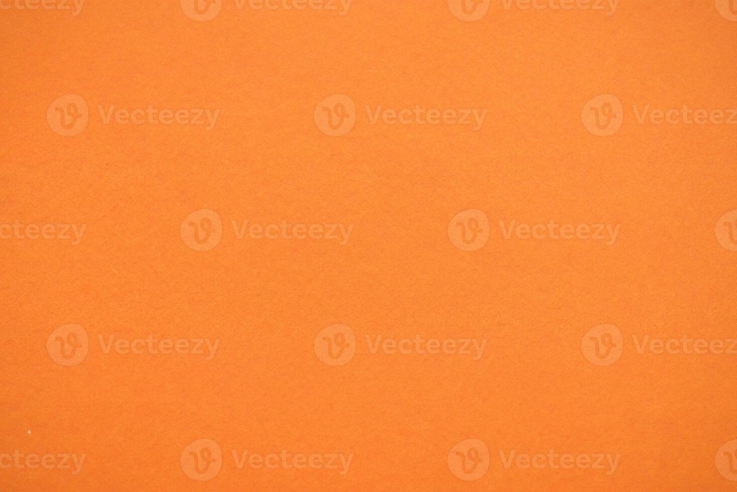 Close-Up Shot of Vibrant Orange Paper Texture photo