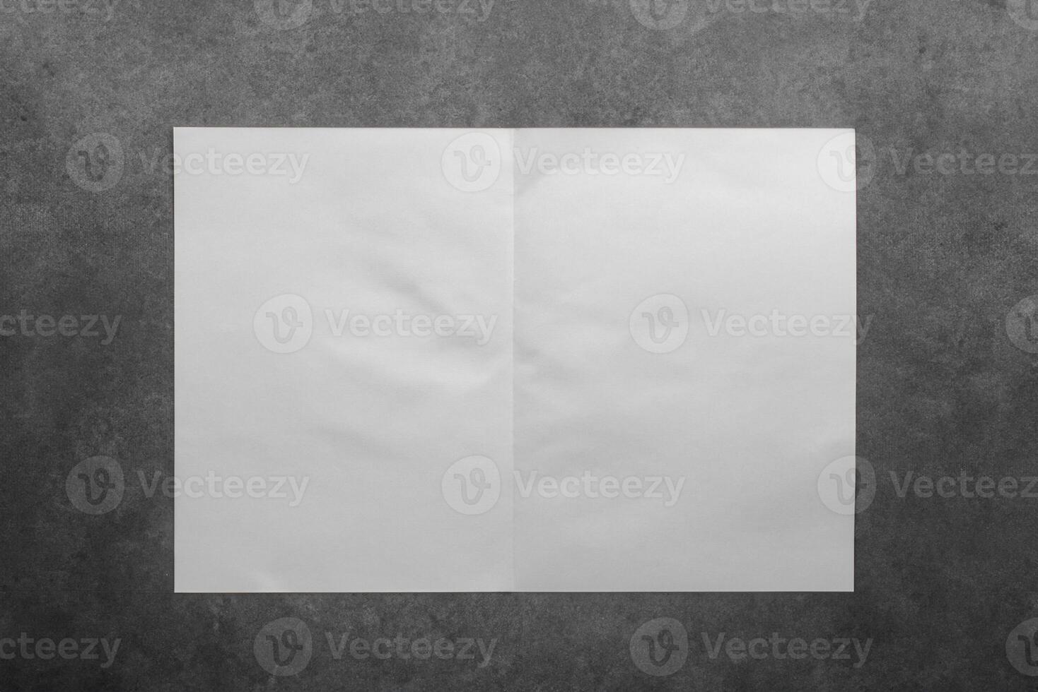 Minimalist Paper Fold Composition Against Concrete Wall Background photo