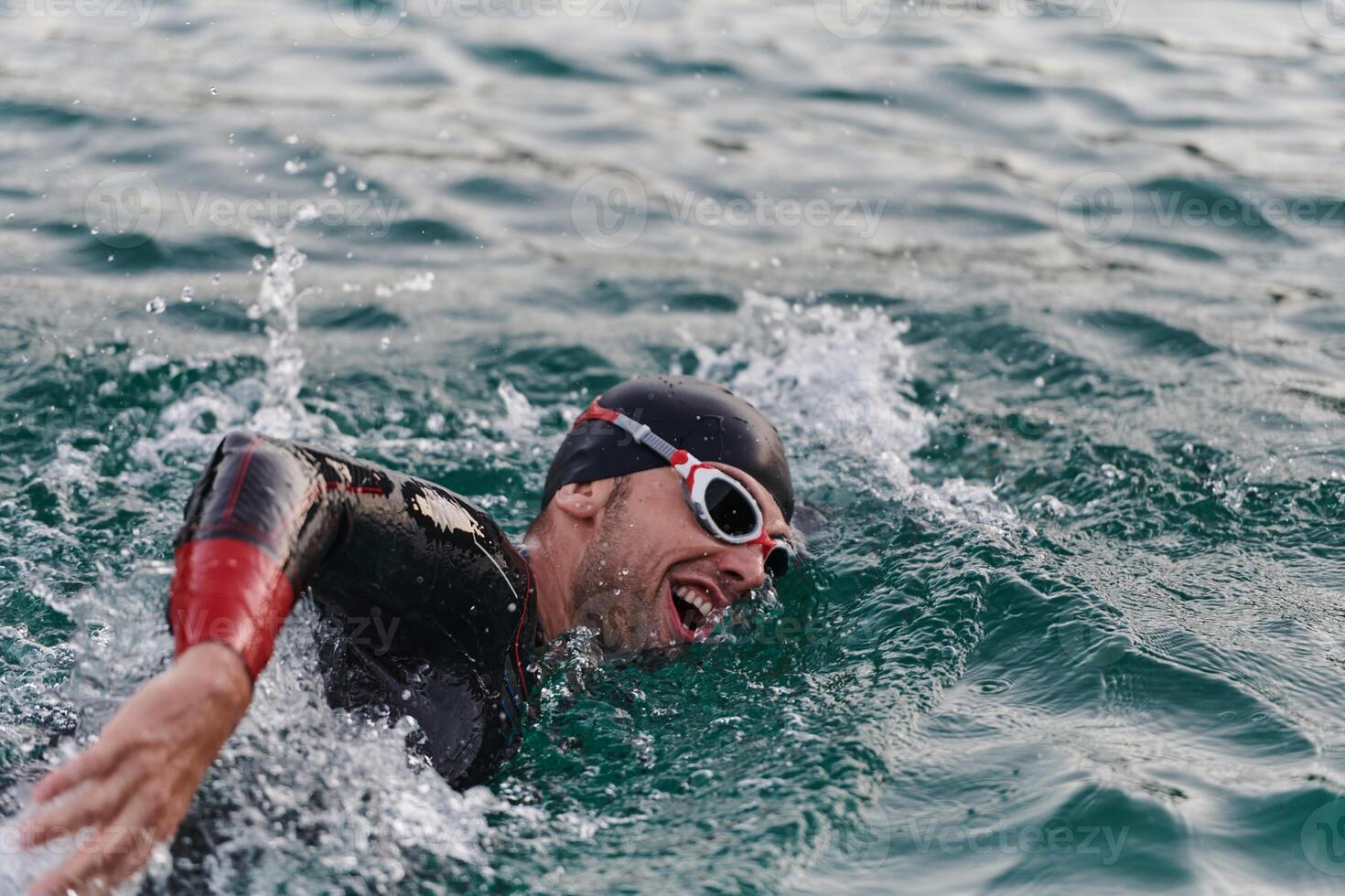A professional triathlete trains with unwavering dedication for an upcoming competition at a lake, emanating a sense of athleticism and profound commitment to excellence. photo