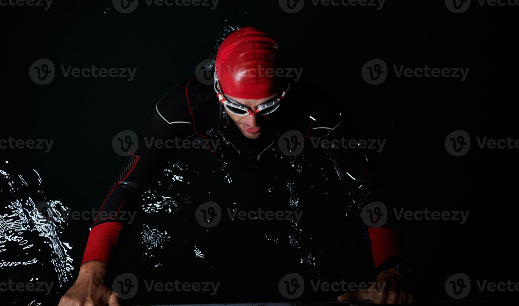 A triathlete finds serene rejuvenation in a lake, basking in the tranquility of the water after an intense training session photo