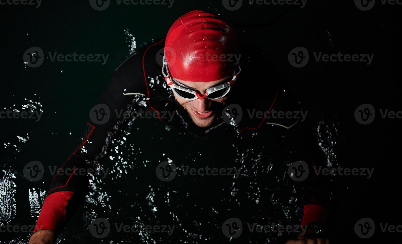 A triathlete finds serene rejuvenation in a lake, basking in the tranquility of the water after an intense training session photo