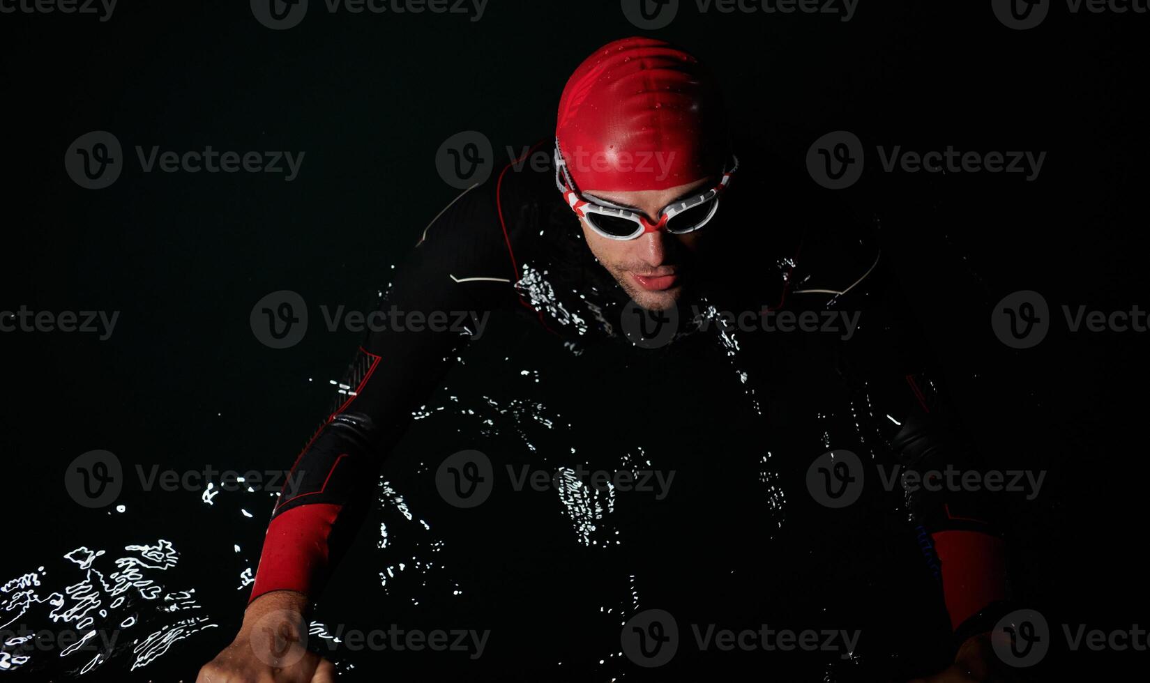 A triathlete finds serene rejuvenation in a lake, basking in the tranquility of the water after an intense training session photo
